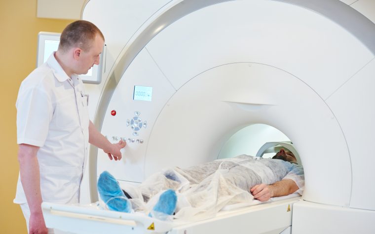 A patient undergoing a PET scan, allowing treating clinicians to monitor the response to cancer treatment in non-small cell lung cancer patients.